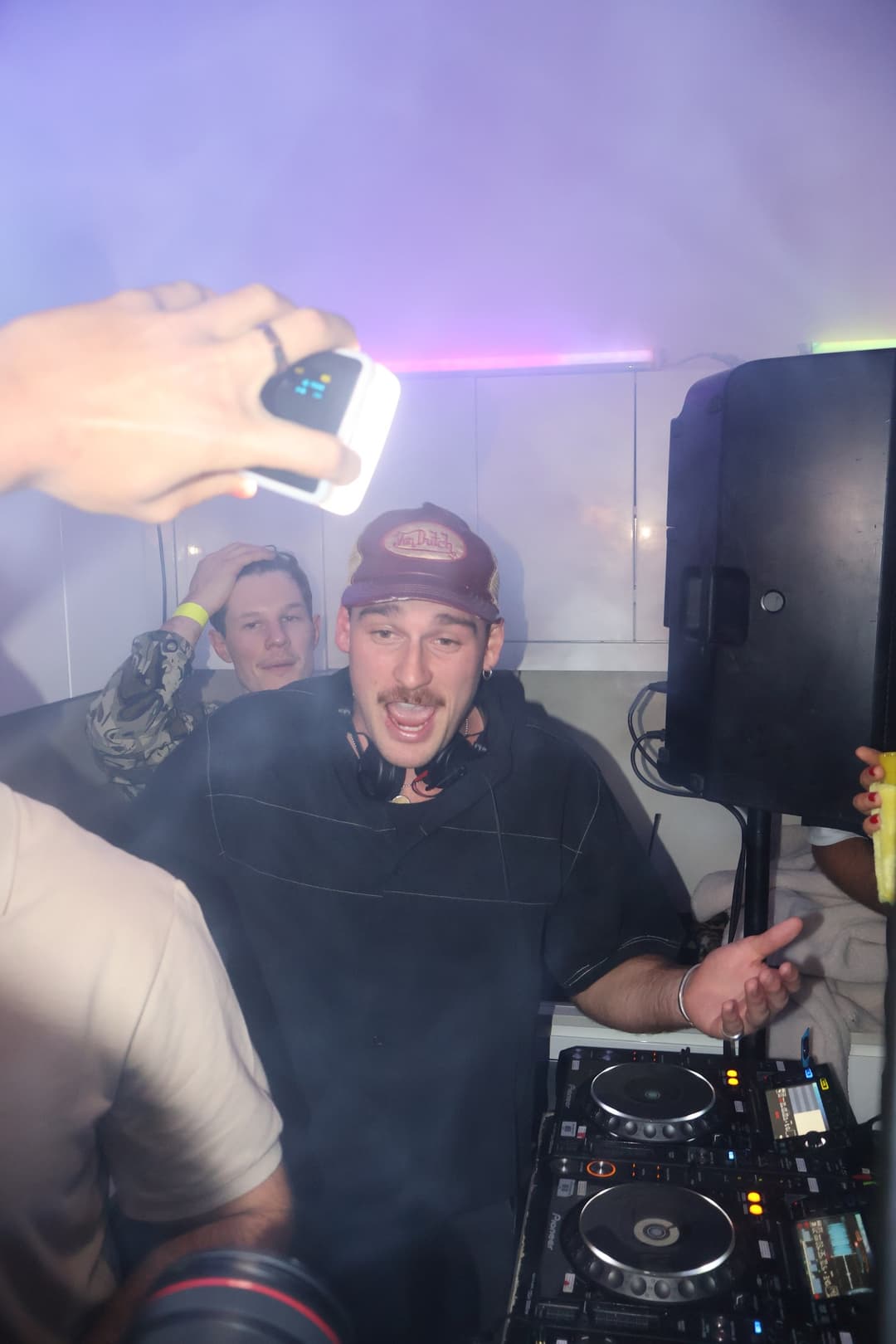 Behind the booth with a can