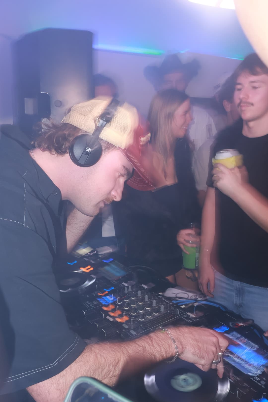 Headphones on, crowd behind