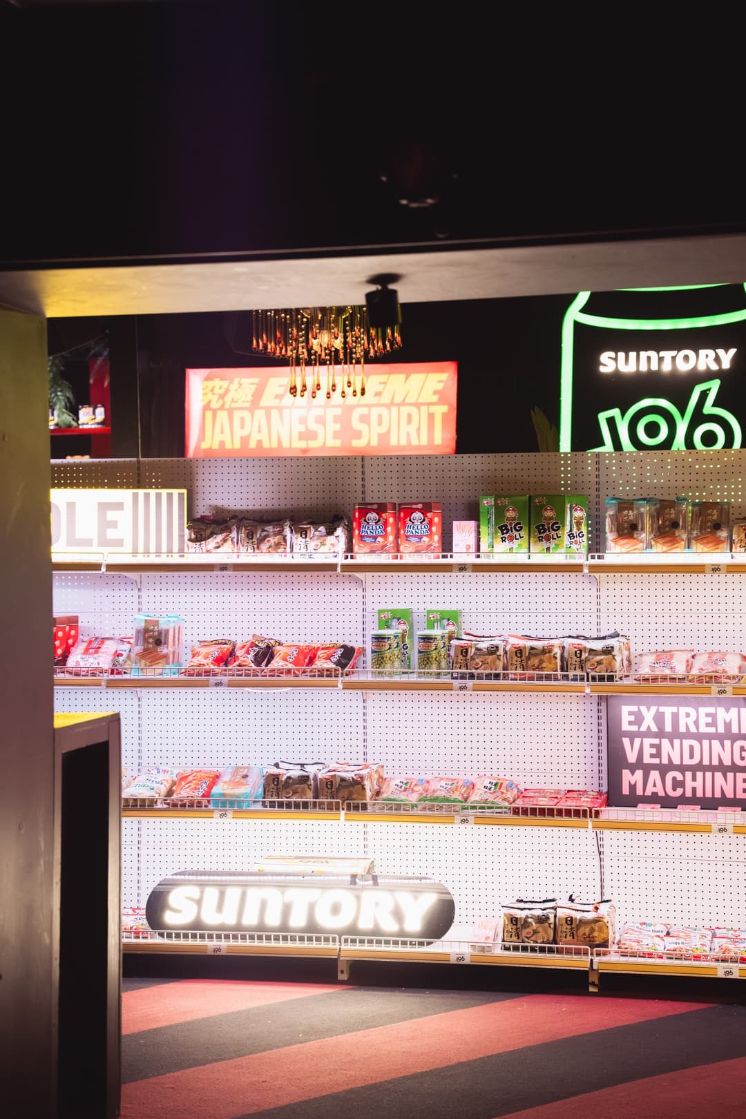 Neon-lit konbini shelving stocked with snacks and -196