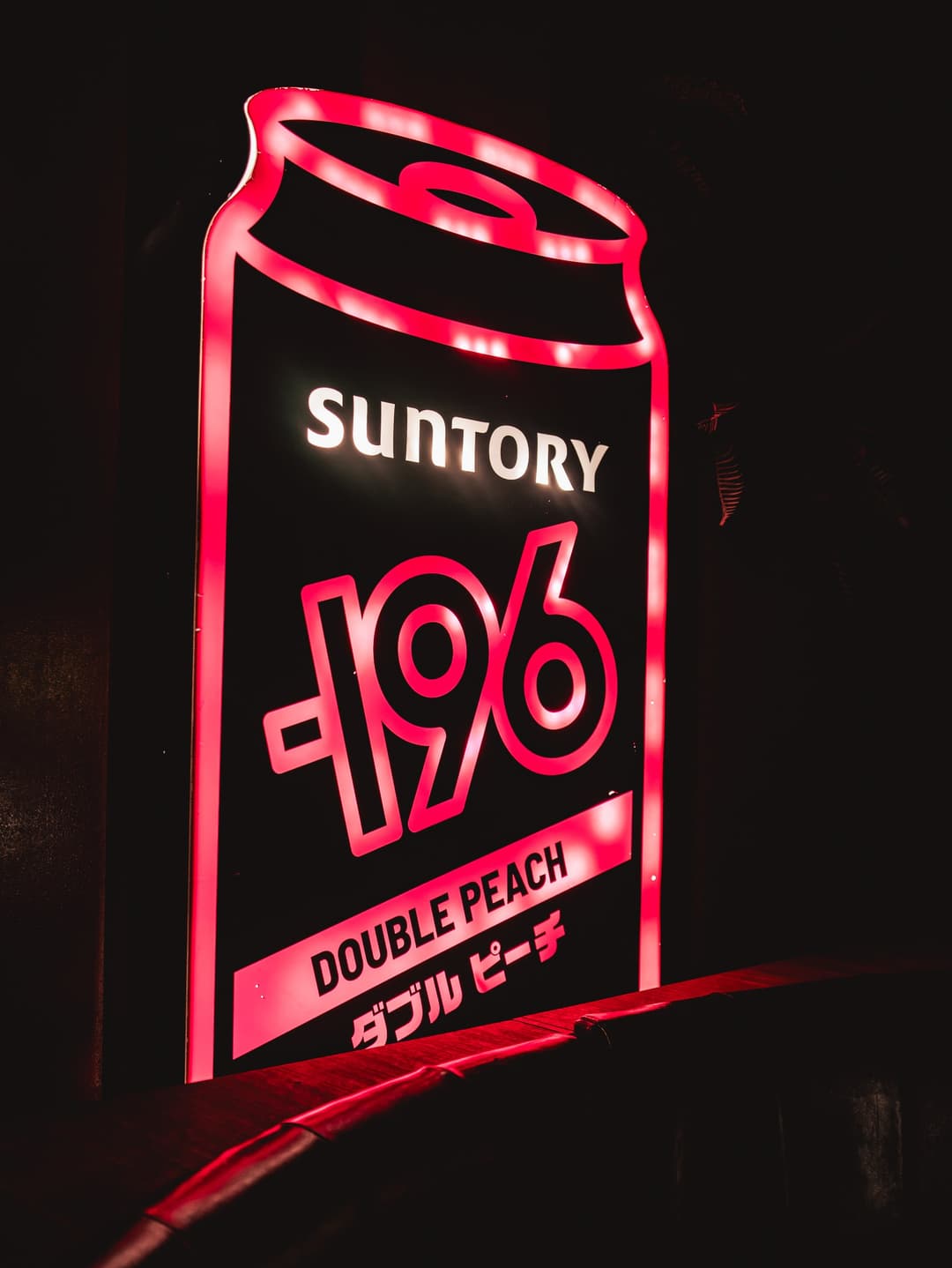 Neon Suntory -196 Double Peach sign inside the konbini
