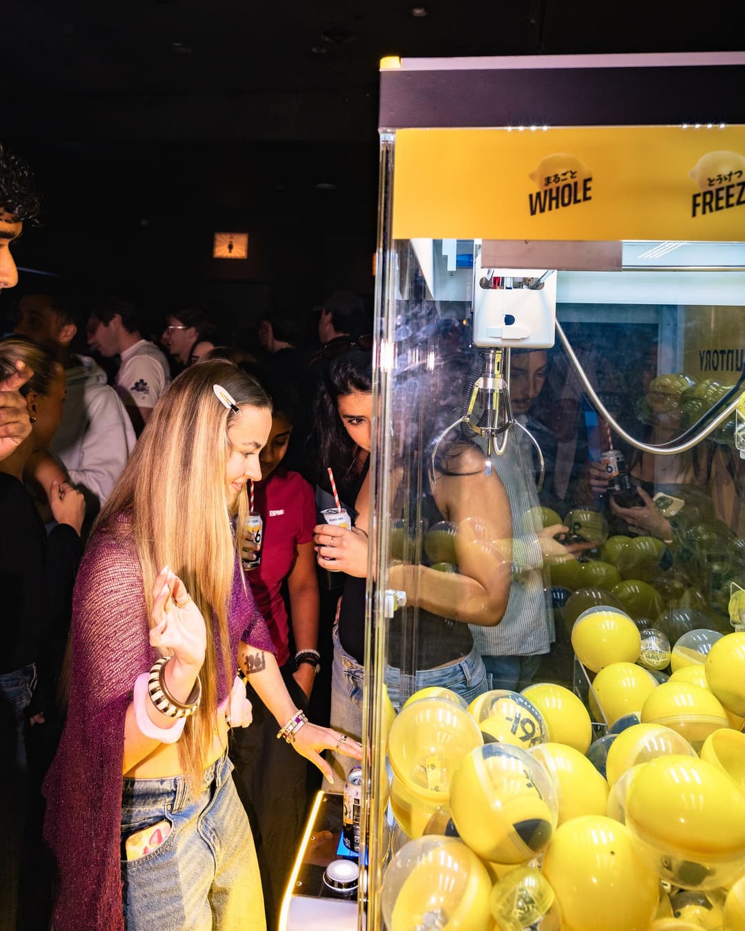The Gashapon claw machine full of yellow capsules