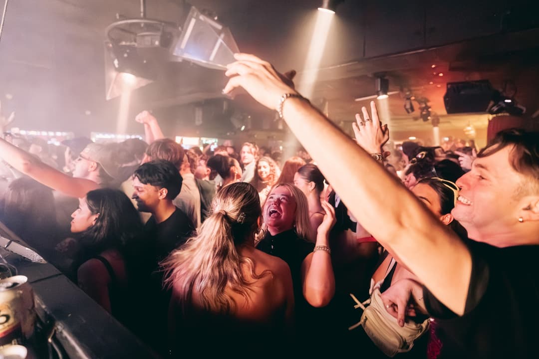 A guest pointing to the booth from the crowd