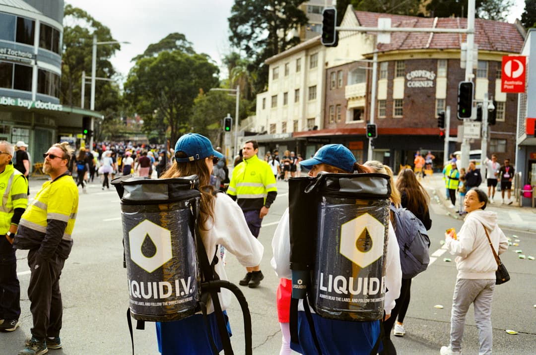 Liquid I.V. branded backpacks dispensing water along the City2Surf course