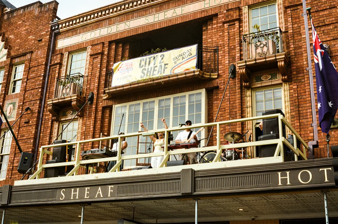 The City2Sheaf x Liquid I.V. banner above The Golden Sheaf balcony